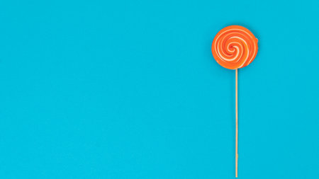 Lollipop on a blue background with text space. high quality photoの写真素材