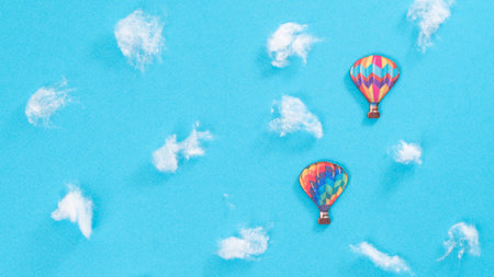 Two colorful air balloons among the white clouds