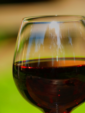 Crystal glass of wine. Green background.の写真素材