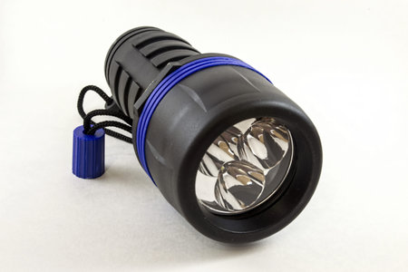 Photo of black flashlight on a white background