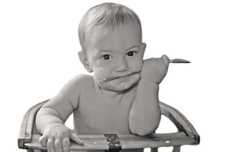 baby boy with spoon over whiteの写真素材