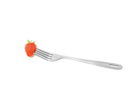 fork with strawberry over whiteの写真素材