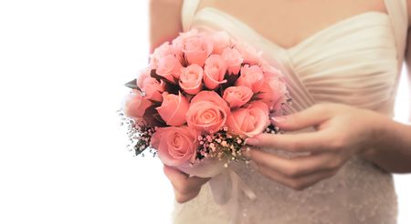 wedding bouquet in bride's hands over whiteの写真素材