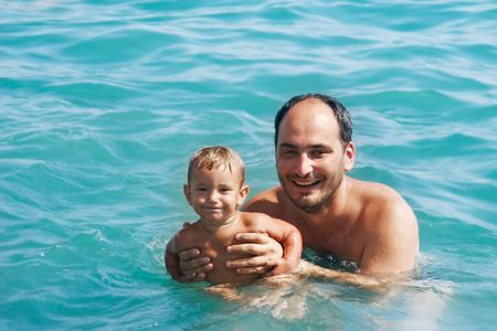 happy father and son in waterの写真素材