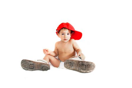 toddler boy in parent's boots over whiteの写真素材