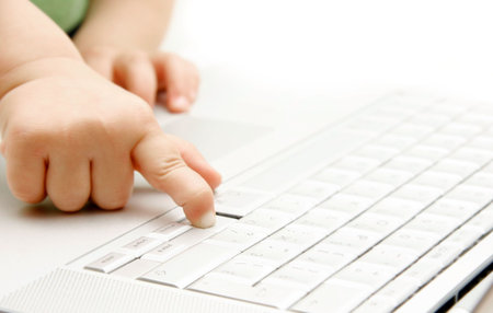 close up of child finger pressing key on laptop keyboardの写真素材