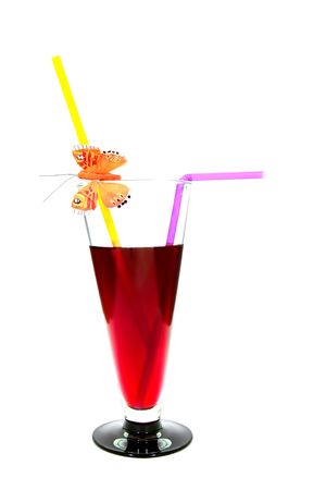 red cocktail in glass with two straws and butterfy over whiteの写真素材