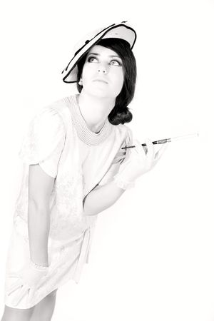 beautiful girl in retro style with cigarette over whiteの写真素材