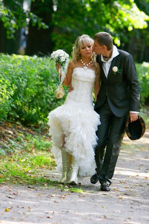loving couple on their wedding day in autumn parkの写真素材