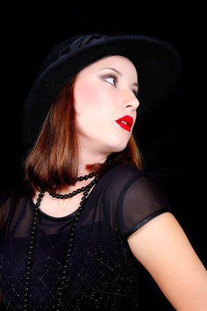 elegant woman in balck dress and hat over black
