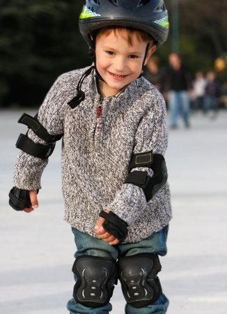 smiling boy in roller blades outdoorの写真素材