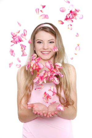 young happy woman in rose petalsの写真素材