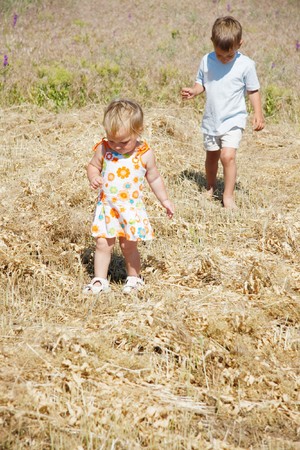 two kids walking on rural backgroundの写真素材