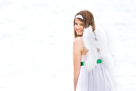 young smiling angel-girl on natural backgroundの写真素材