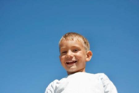 happy boy isolated over blueの写真素材
