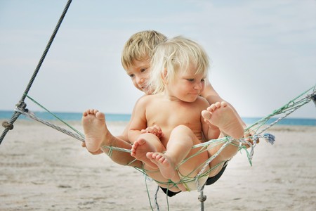 two kids playing on beachの写真素材