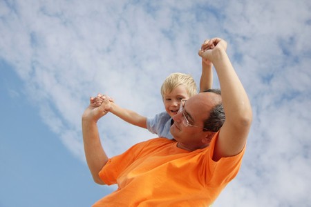 happy father and son on sky backgroundの写真素材