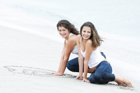 two happy girls on beachの写真素材