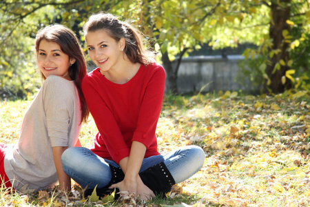 two young happy women on natural backgroundの写真素材