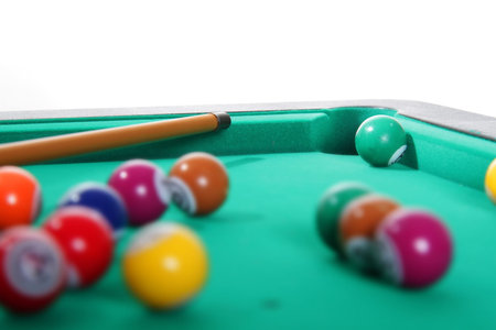 billiard balls and cue on table