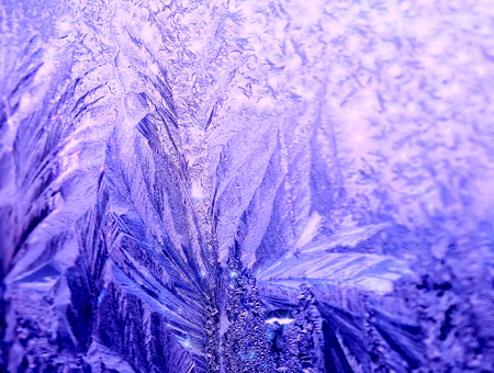 Icy frosty ornate pattern of thin ice on the window.の写真素材