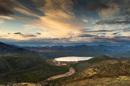 Russia. Magadan Region. A beautiful forest lake against the backdrop of the Big Anngachak mountain range. Autumn in the vicinity of Lake Jack London.の写真素材