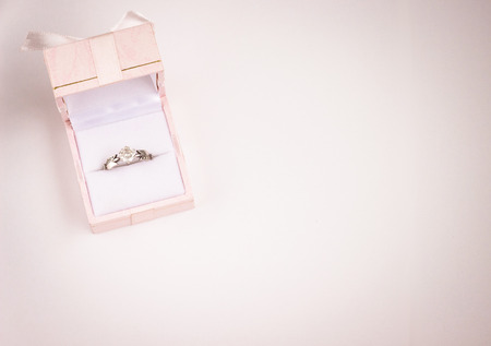silver, diamond, wedding ring in pink box, white background closeupの写真素材