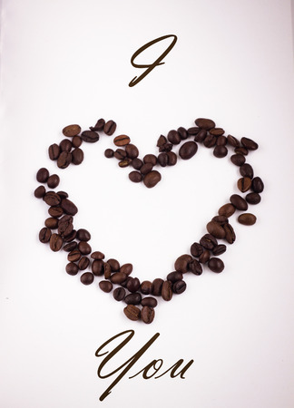 Coffee beans in heart shape, white background, i love you textの写真素材