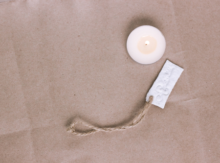 White key stamp and candle on brown backgroundの写真素材