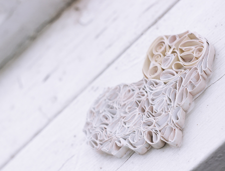White handmade paper heart on old windowの写真素材