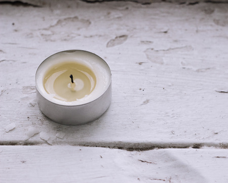 small candle on white window closeupの写真素材
