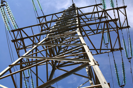 The metal structure of the electrical towers in the blue sky.