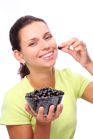 Smiling young woman with bowl full of black currants in her hands.の写真素材