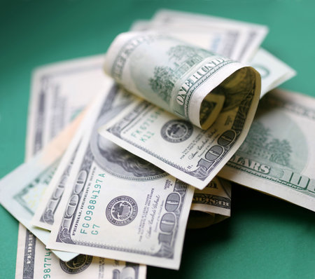 Dollars. Some piece of money over green background.