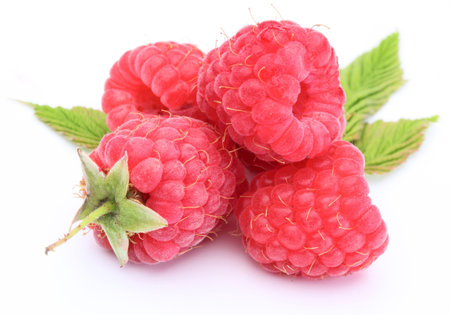 Macro shot of appetizing raspberries over white.
