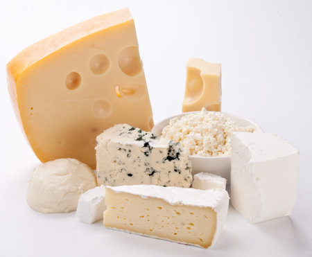 Various types of cheeses on a white background. 