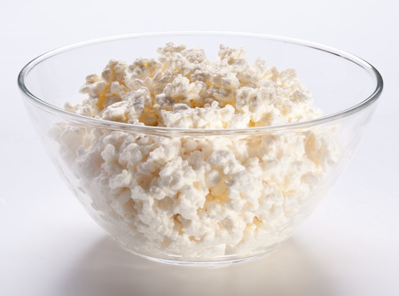 Bowl with fresh cottage cheese. Isolated on a white.の写真素材