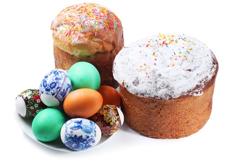 Multi-colored eggs on a plate and cakes. Easter holiday. Isolated on a whiteの写真素材