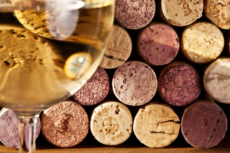 Image of wine corks through a glass of white wine.の写真素材