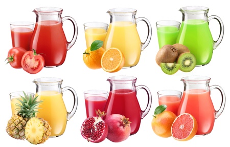 Collection of fresh juices in pitchers. Nearby are the ingredients of juices.の写真素材