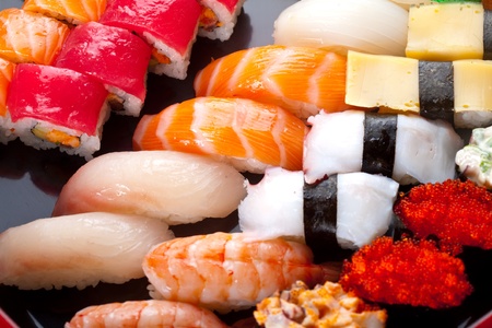 Sushi rolls on a black plate の写真素材