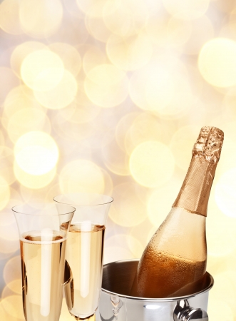 Two champagne glass with bottle on a yellow blur background の写真素材