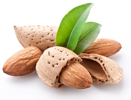 Group of almond nuts with leaves. Isolated on a white background.の写真素材