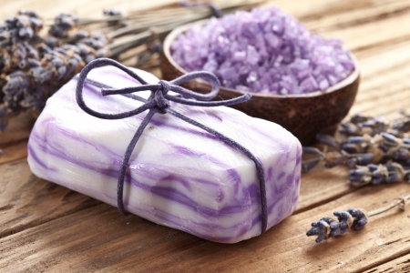 Soap with sea-salt and dried lavender on wood desk.の写真素材