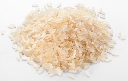 Handful of rice on a white background.の写真素材