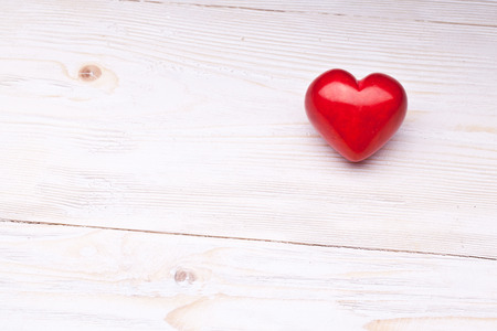 Valentines Day. Red heart on a white wooden table.の写真素材