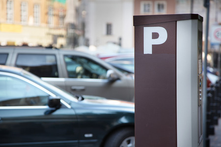 Parking meter in the town. Blurred cars on the background.の写真素材