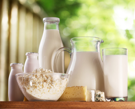 Dairy products on old wooden table. Behind - rural background blur.の写真素材