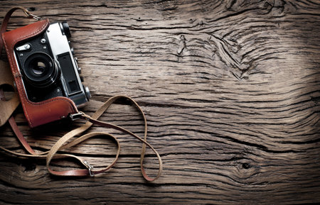 Old rangefinder camera on the old wooden table.