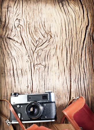 Old rangefinder camera on the old wooden table.の写真素材